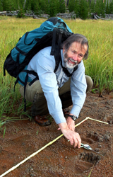 Jim Halfpenny measuring grizzly tracks